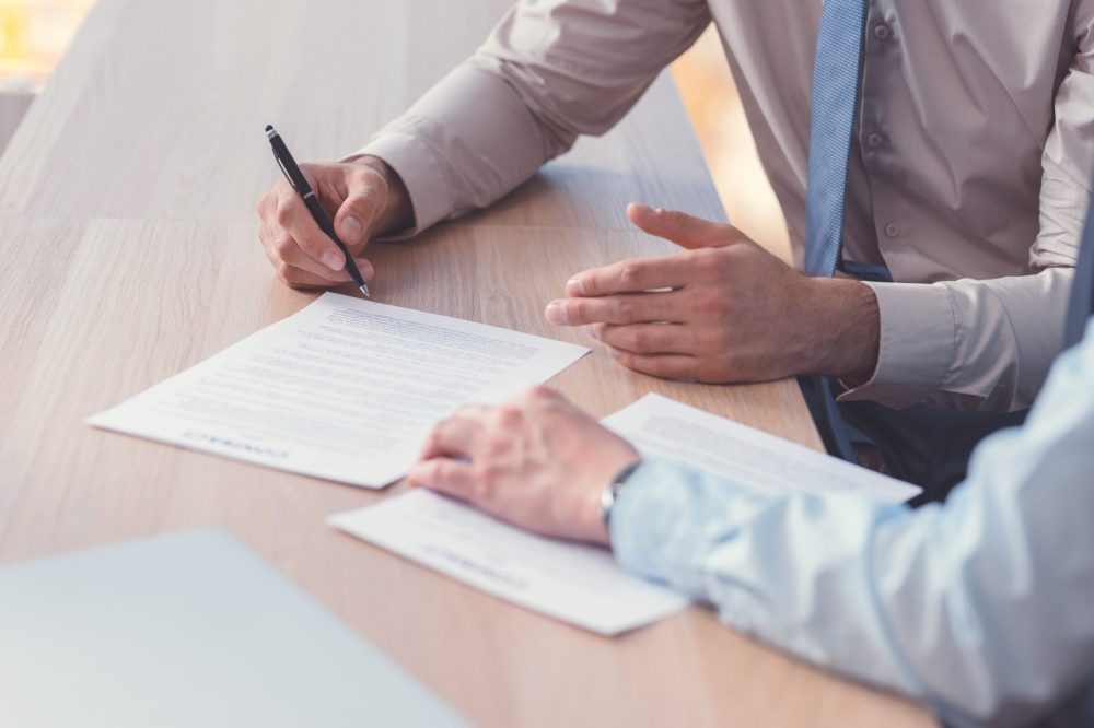 Business people signing a contract closeup